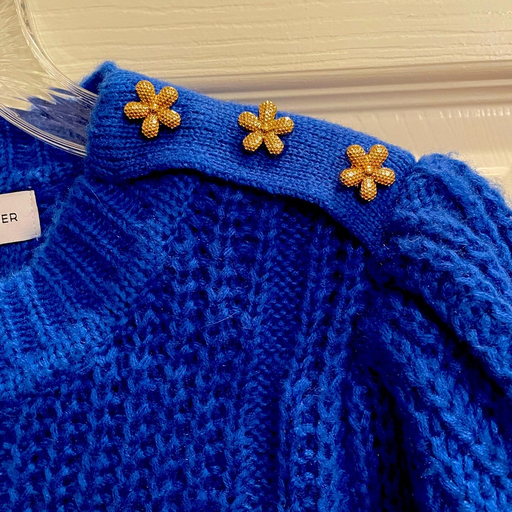 Royal blue sweater with gold flowers on left shoulder